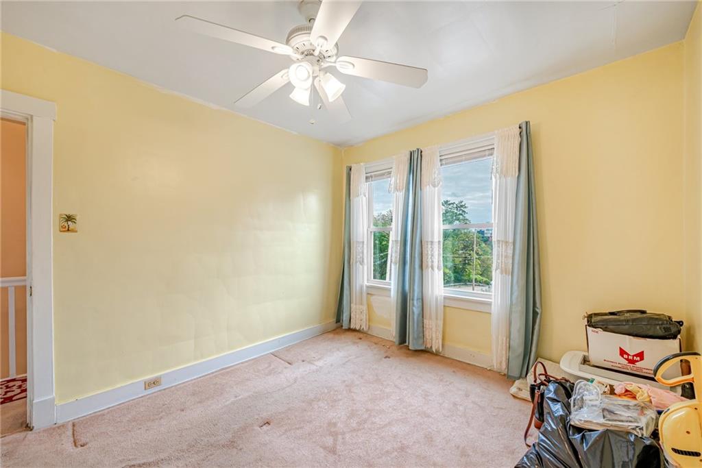 2539 Mahon Street Pittsburgh, PA 15219 - Photo 19 of 24 an empty room with a ceiling fan and a window