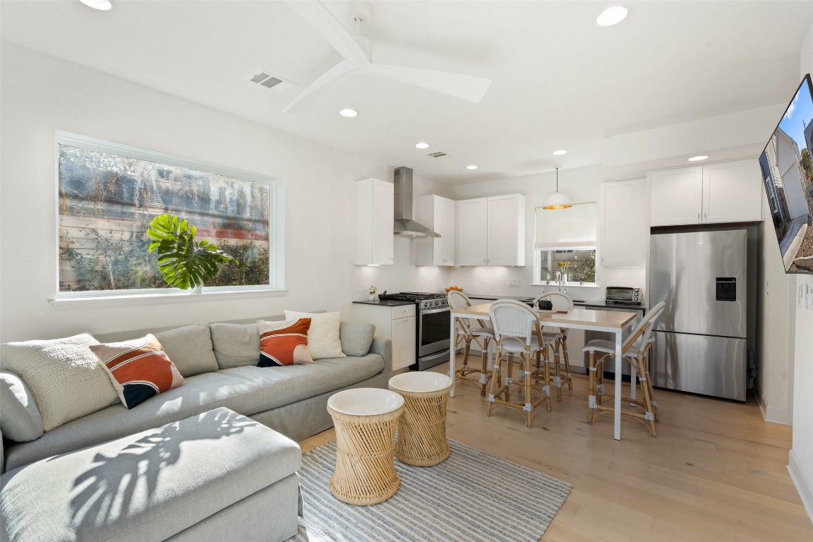 209 Ben Howell Drive, Unit B Austin, TX 78704 - Photo 15 of 39 a living room with furniture and a dining table with kitchen view