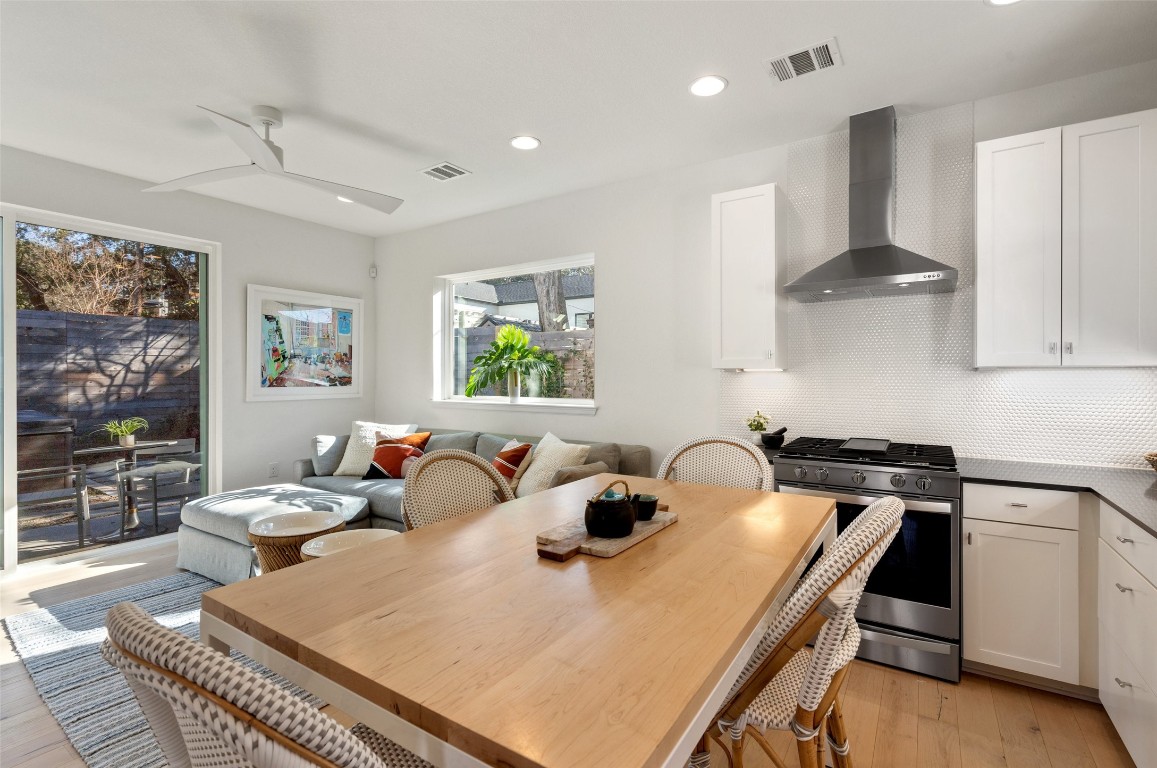 209 Ben Howell Drive, Unit B Austin, TX 78704 - Photo 17 of 39 a kitchen with a stove a sink a dining table and chairs