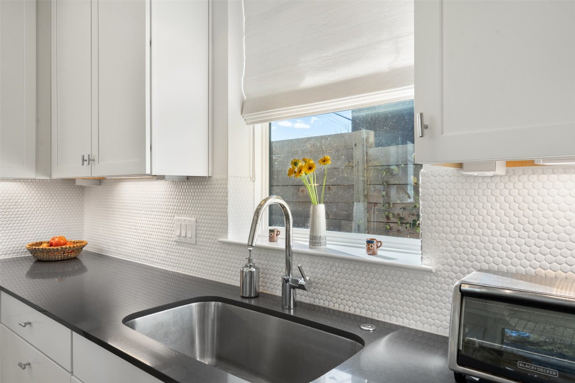 209 Ben Howell Drive, Unit B Austin, TX 78704 - Photo 23 of 39 a kitchen with a sink and a stove top oven