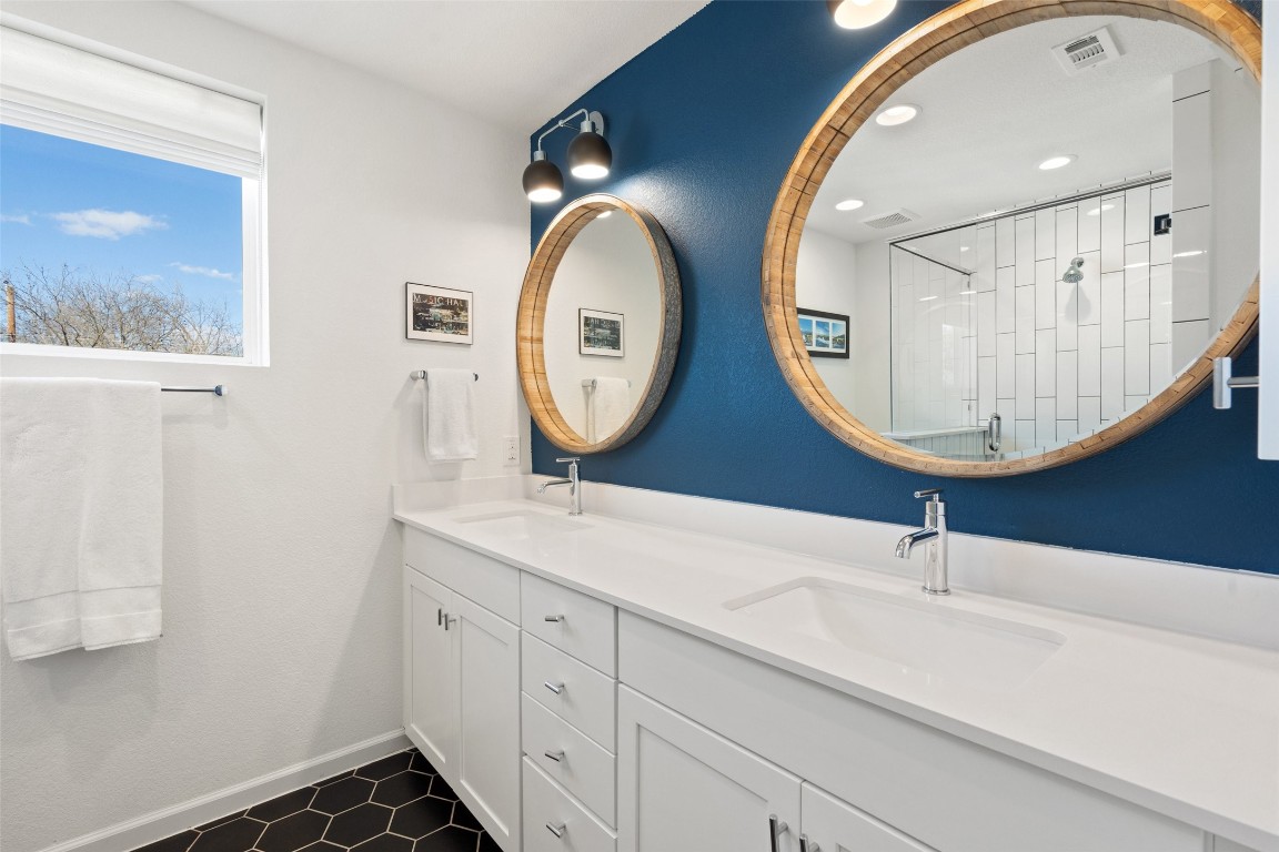 209 Ben Howell Drive, Unit B Austin, TX 78704 - Photo 27 of 39 a bathroom with a sink and a mirror