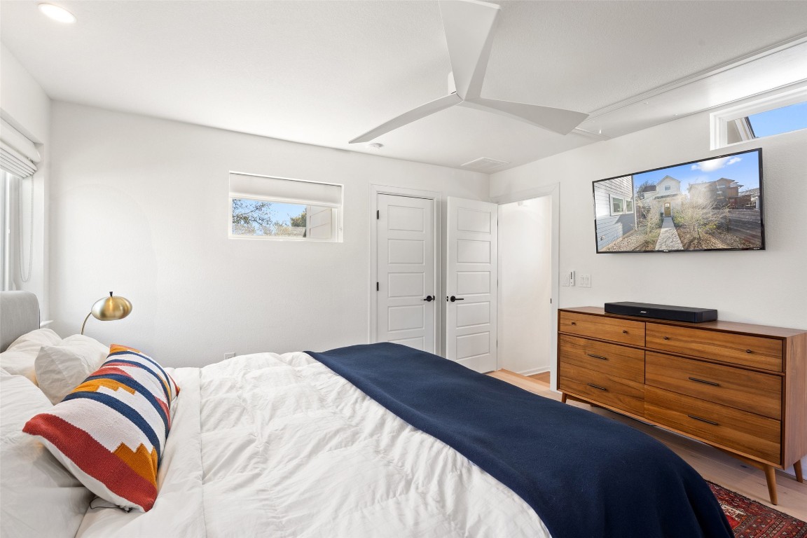 209 Ben Howell Drive, Unit B Austin, TX 78704 - Photo 29 of 39 a bedroom with a bed and a painting on the wall