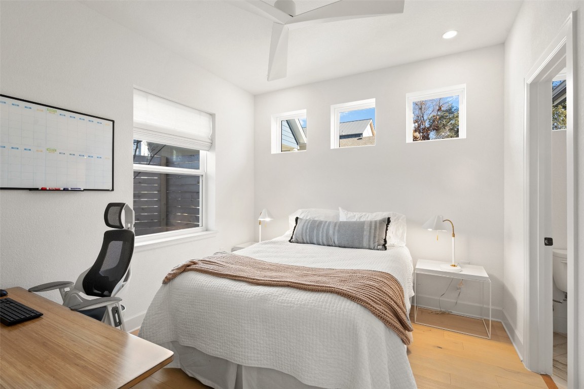 209 Ben Howell Drive, Unit B Austin, TX 78704 - Photo 31 of 39 a bedroom with a bed a painting on the wall and a dresser