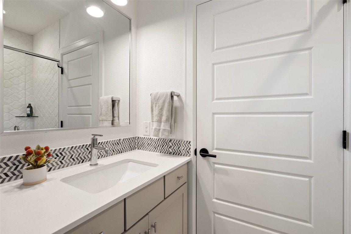 209 Ben Howell Drive, Unit B Austin, TX 78704 - Photo 34 of 39 a bathroom with a sink and a mirror