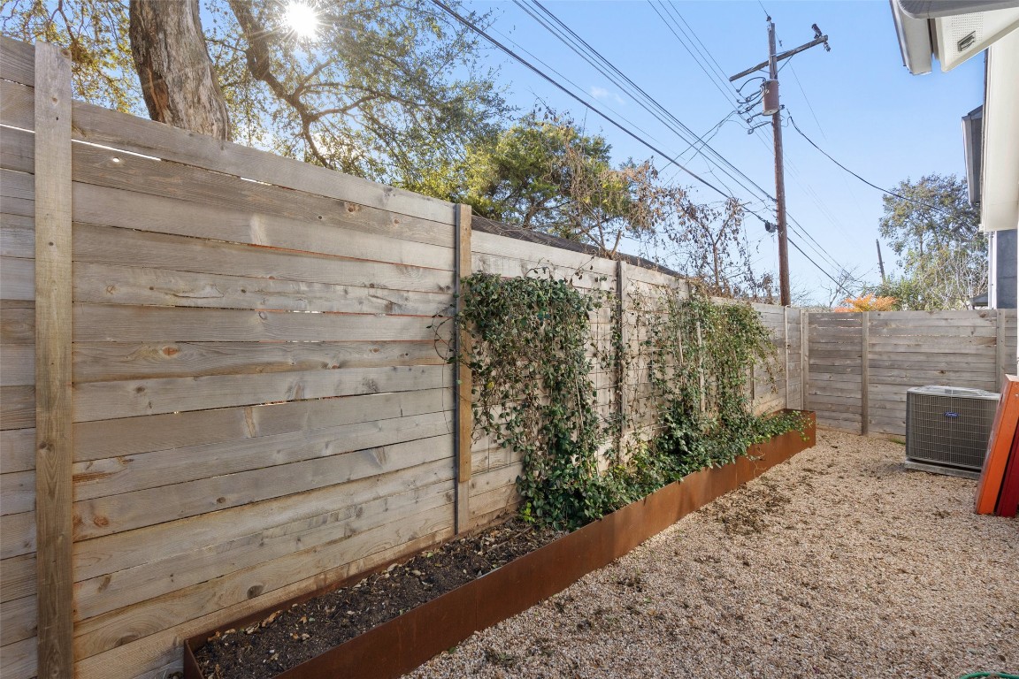 209 Ben Howell Drive, Unit B Austin, TX 78704 - Photo 37 of 39 a view of a backyard with plants and a bench