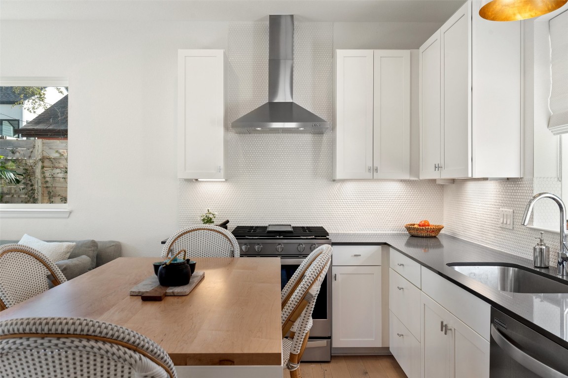 209 Ben Howell Drive, Unit B Austin, TX 78704 - Photo 4 of 39 a kitchen with a sink a stove and a dining table