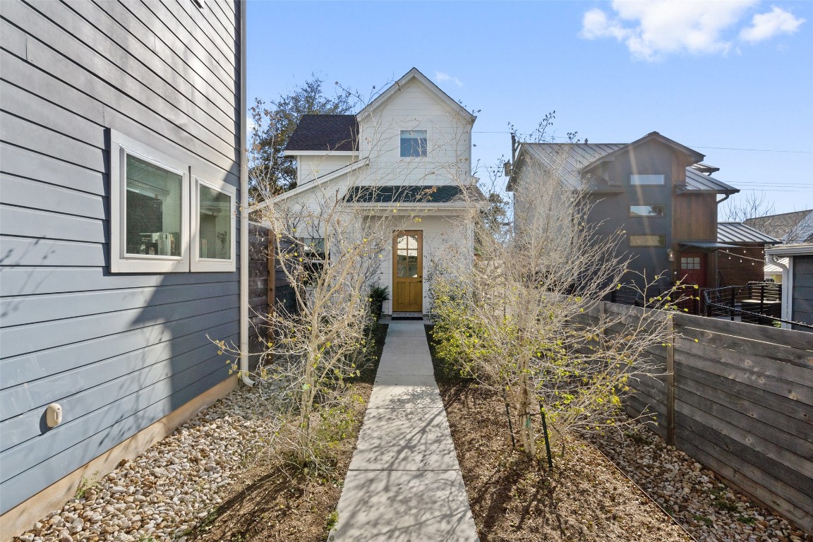 209 Ben Howell Drive, Unit B Austin, TX 78704 - Photo 9 of 39 a front view of a house with garden