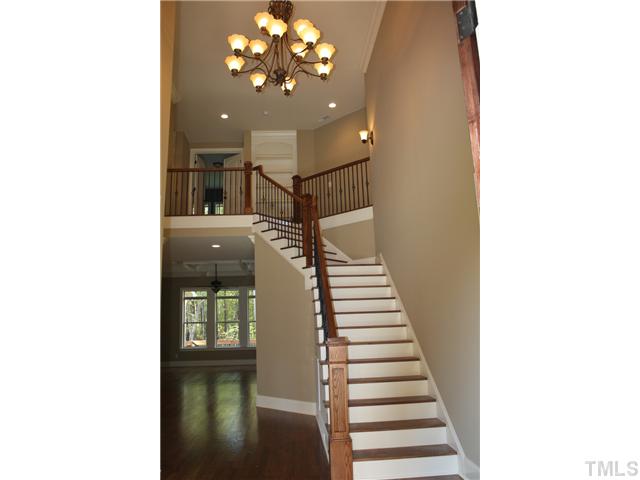 6829 Mactavish Way Raleigh, NC 27613 - Photo 3 of 25 a view of a hallway with entryway wooden floor and front door