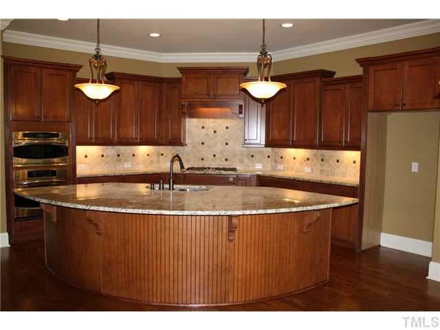 6829 Mactavish Way Raleigh, NC 27613 - Photo 6 of 25 a kitchen with a sink a cabinets and stainless steel appliances
