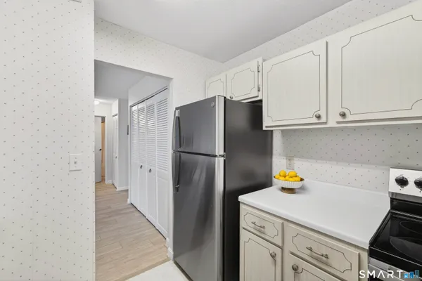 a kitchen with a refrigerator and cabinets