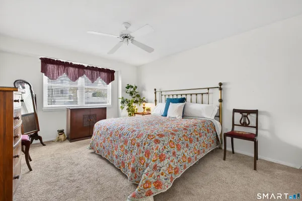 a bedroom with a bed a table and chair
