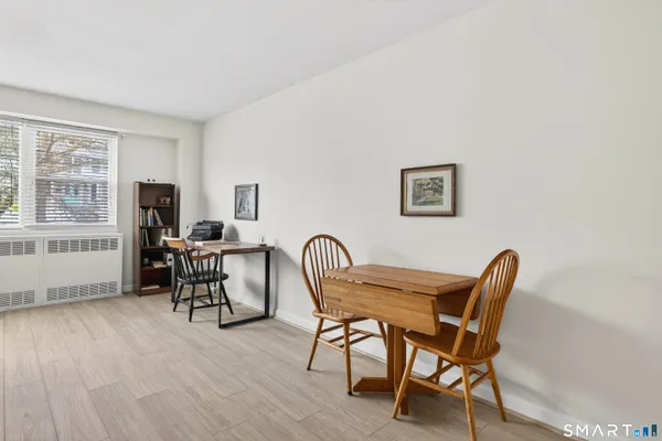a dining room with furniture and window