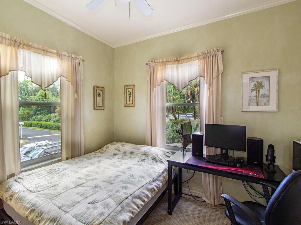 519 Roma Court, Unit 3201 Naples, FL 34110 - Photo 11 of 17 a bedroom with a bed and a window