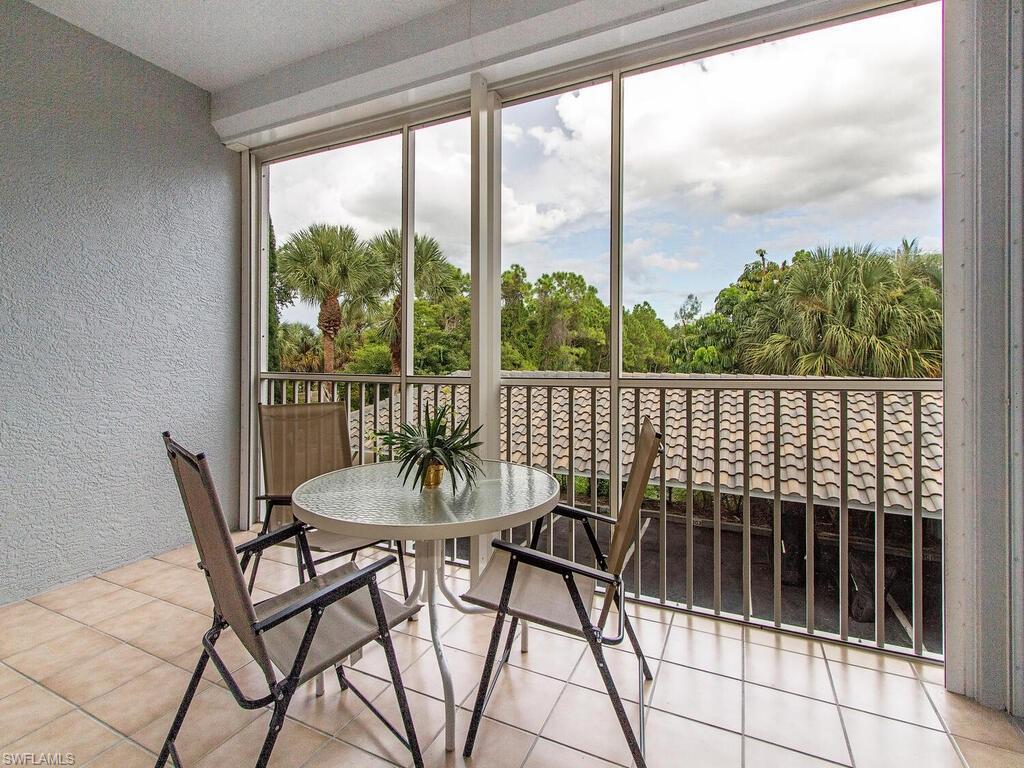 519 Roma Court, Unit 3201 Naples, FL 34110 - Photo 12 of 17 a dining room with furniture and a floor to ceiling window