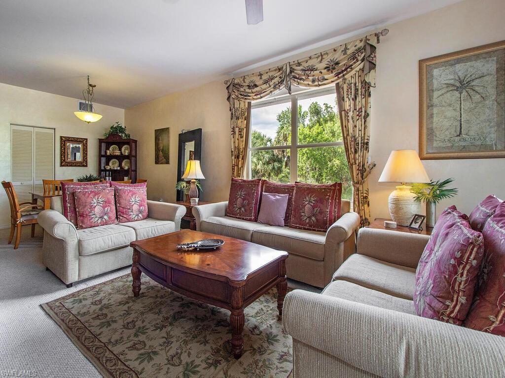 519 Roma Court, Unit 3201 Naples, FL 34110 - Photo 2 of 17 a living room with furniture and a large window