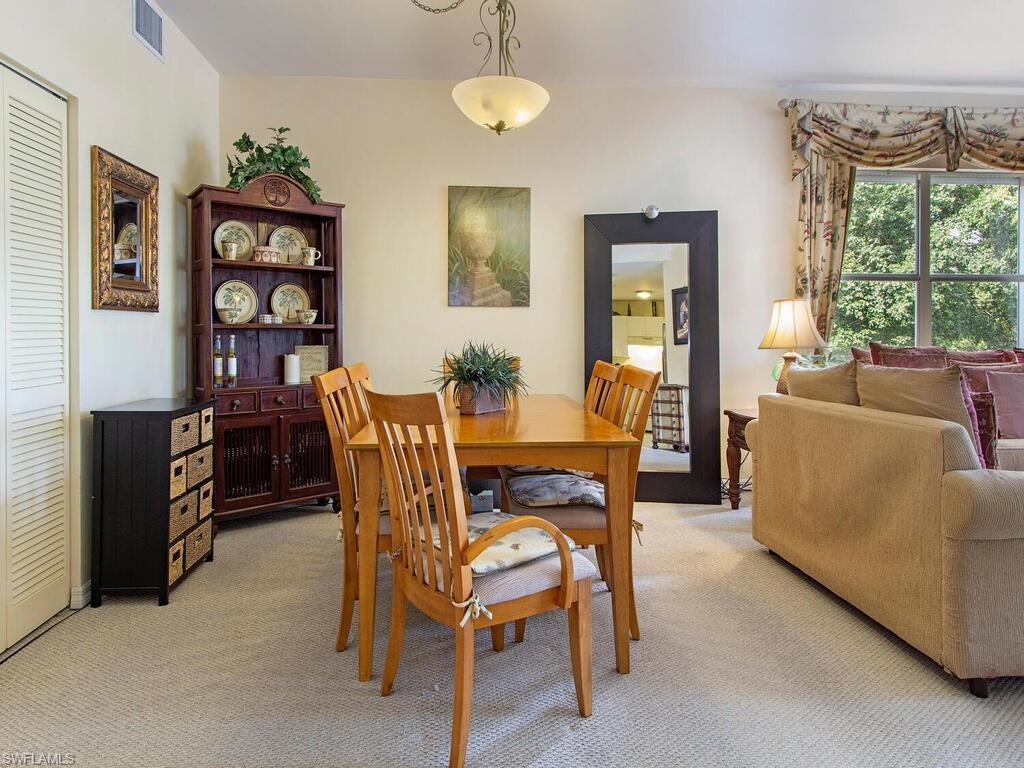 519 Roma Court, Unit 3201 Naples, FL 34110 - Photo 4 of 17 a dining room with furniture and window