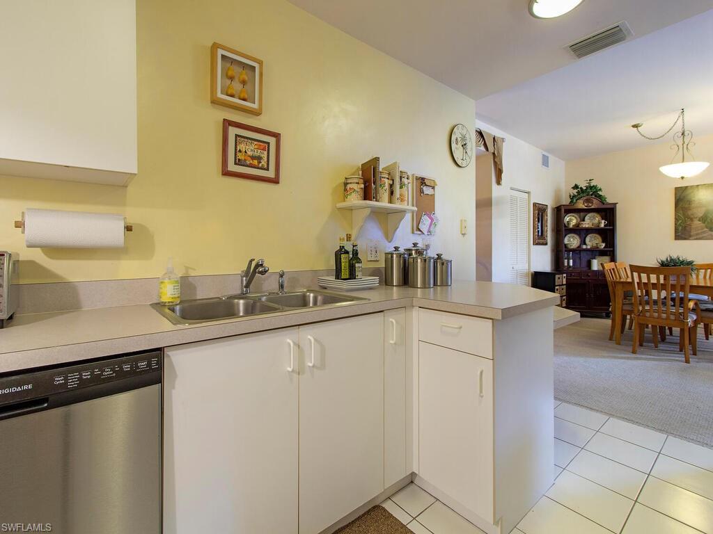 519 Roma Court, Unit 3201 Naples, FL 34110 - Photo 6 of 17 a kitchen with a sink and cabinets