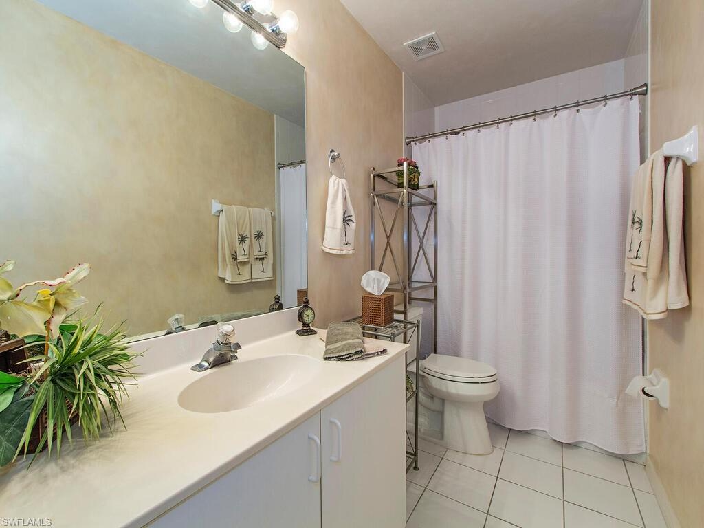 519 Roma Court, Unit 3201 Naples, FL 34110 - Photo 7 of 17 a bathroom with a sink toilet and shower