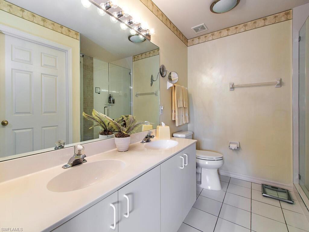 519 Roma Court, Unit 3201 Naples, FL 34110 - Photo 9 of 17 a bathroom with a sink a toilet and shower