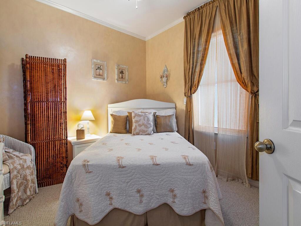 519 Roma Court, Unit 3201 Naples, FL 34110 - Photo 10 of 17 a bedroom with a bed and wooden floor