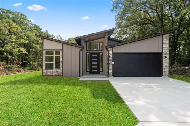 a front view of house with yard and green space