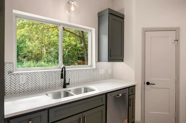 a view of bathroom with a sink and mirror
