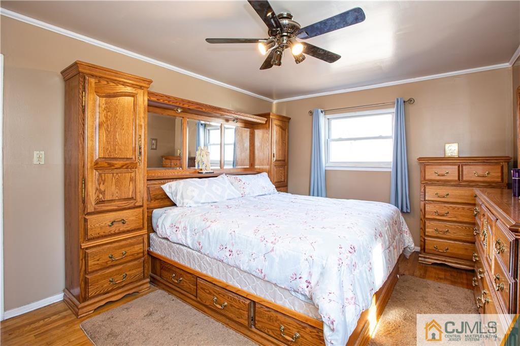 7 Fulton Road Somerset, NJ 08873 - Photo 14 of 24 a spacious bedroom with a bed and a dresser