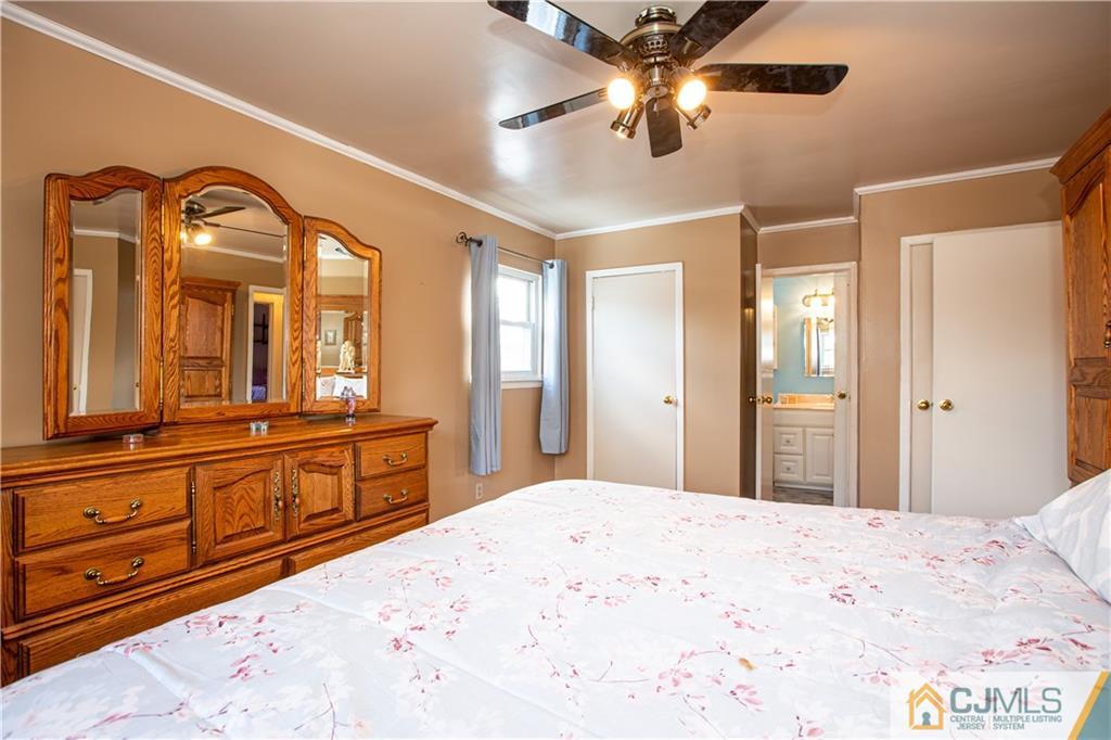 7 Fulton Road Somerset, NJ 08873 - Photo 15 of 24 a bedroom with a large bed and a chandelier