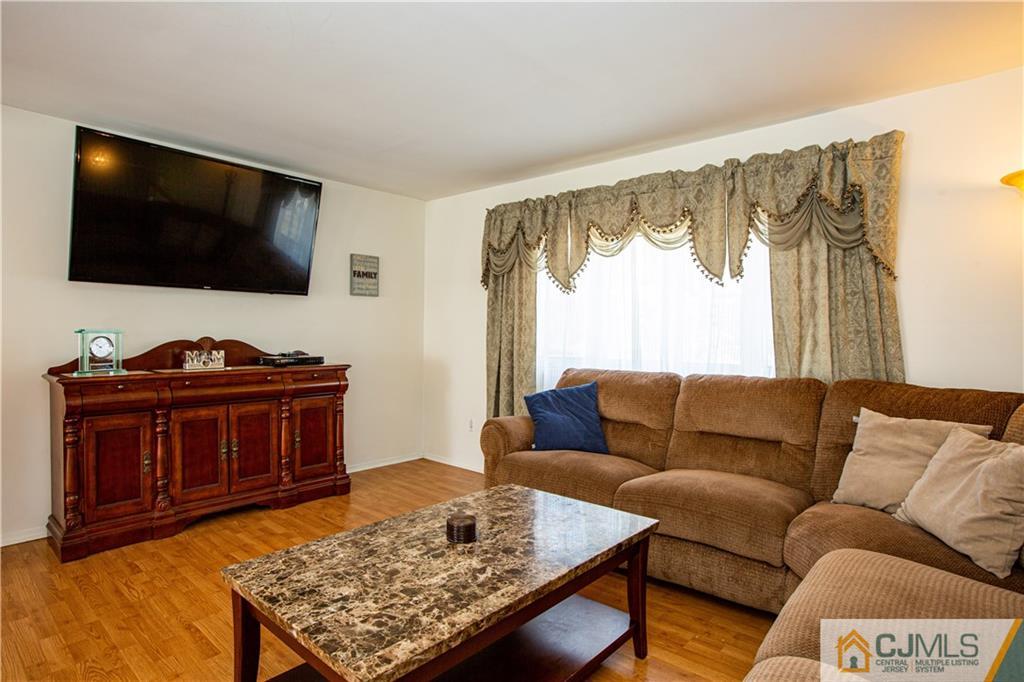7 Fulton Road Somerset, NJ 08873 - Photo 3 of 24 a living room with furniture and a flat screen tv