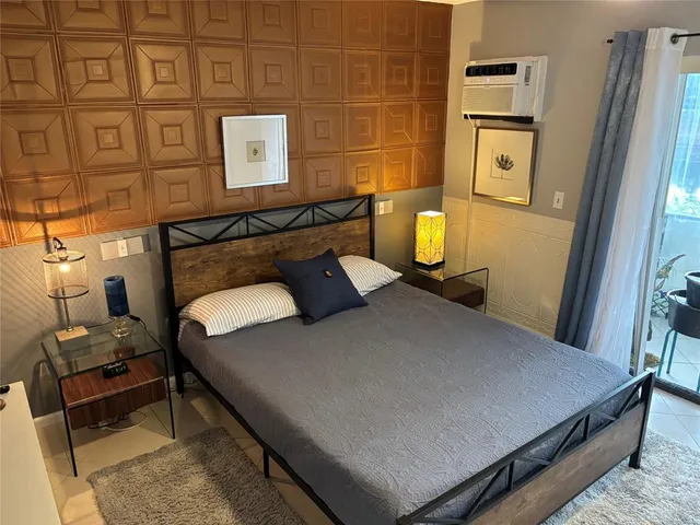 a bed sitting in a bedroom next to a window