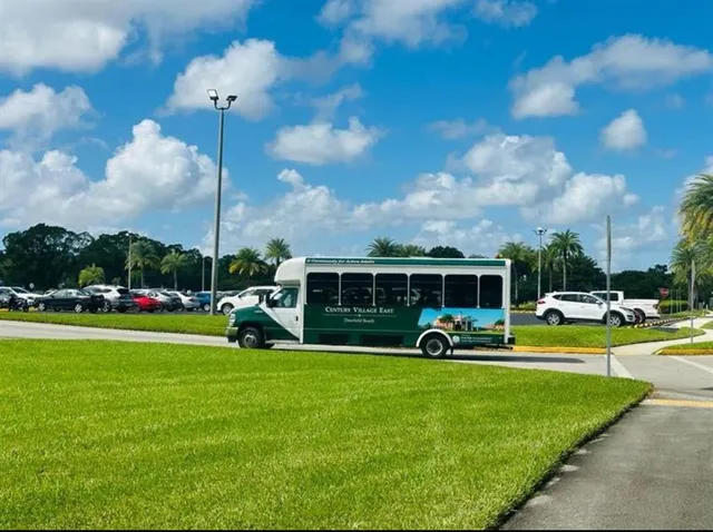 an outdoor space with seating area and trees around