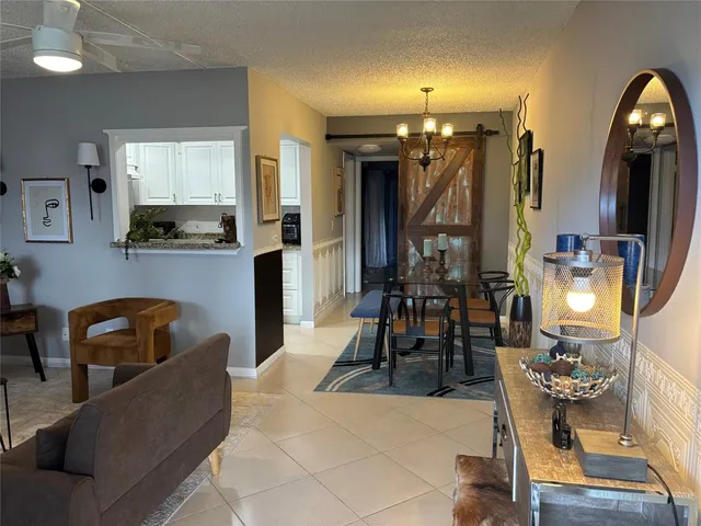 a living room with furniture and dining table