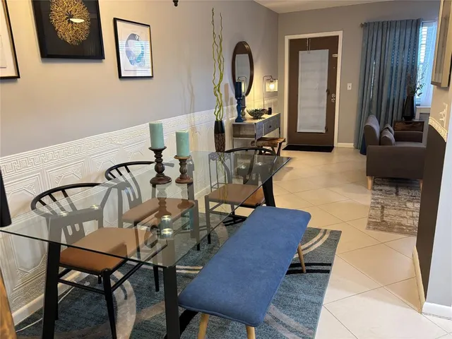 a view of a dining room with furniture a chandelier and wooden floor
