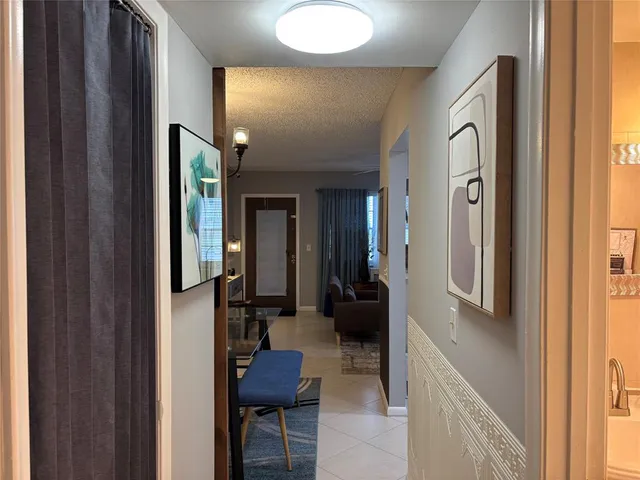 a view of a hallway with living room and furniture