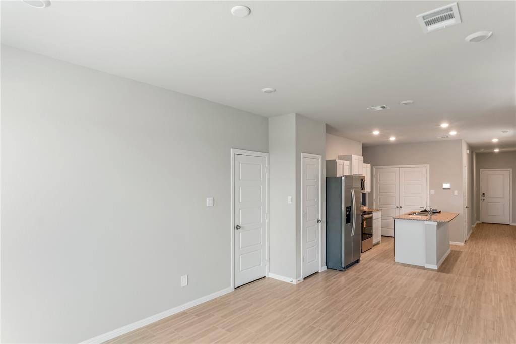 3116 Pecan Farm Lane Fort Worth, TX 76140 - Photo 11 of 25 a view of kitchen with refrigerator stove and wooden floor