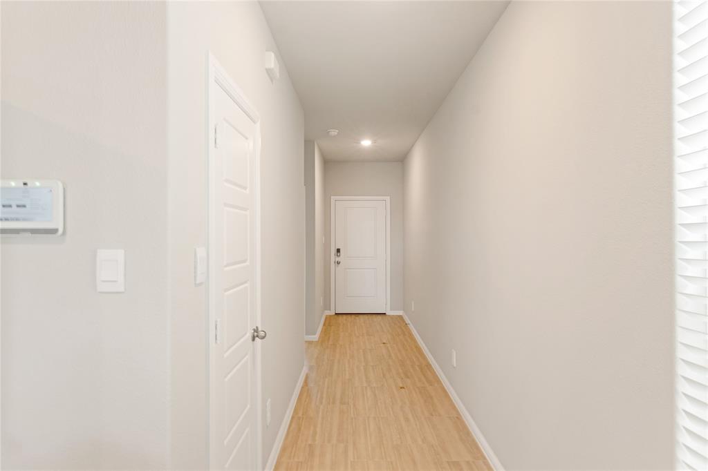 3116 Pecan Farm Lane Fort Worth, TX 76140 - Photo 21 of 25 a view of a hallway with wooden floor and a bathroom