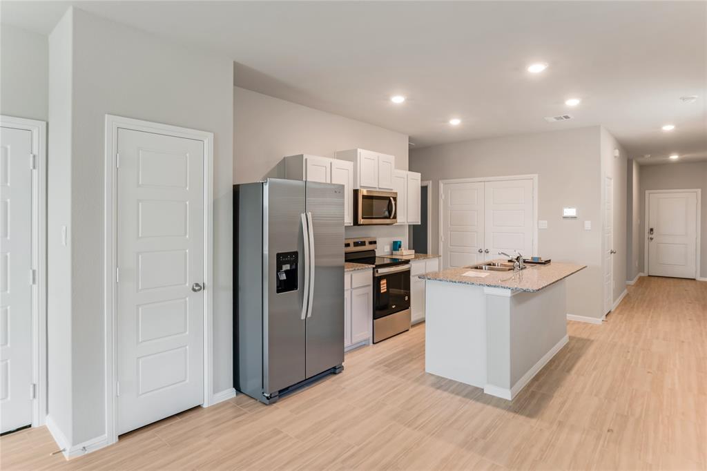 3116 Pecan Farm Lane Fort Worth, TX 76140 - Photo 5 of 25 a kitchen with a refrigerator a sink and a stove