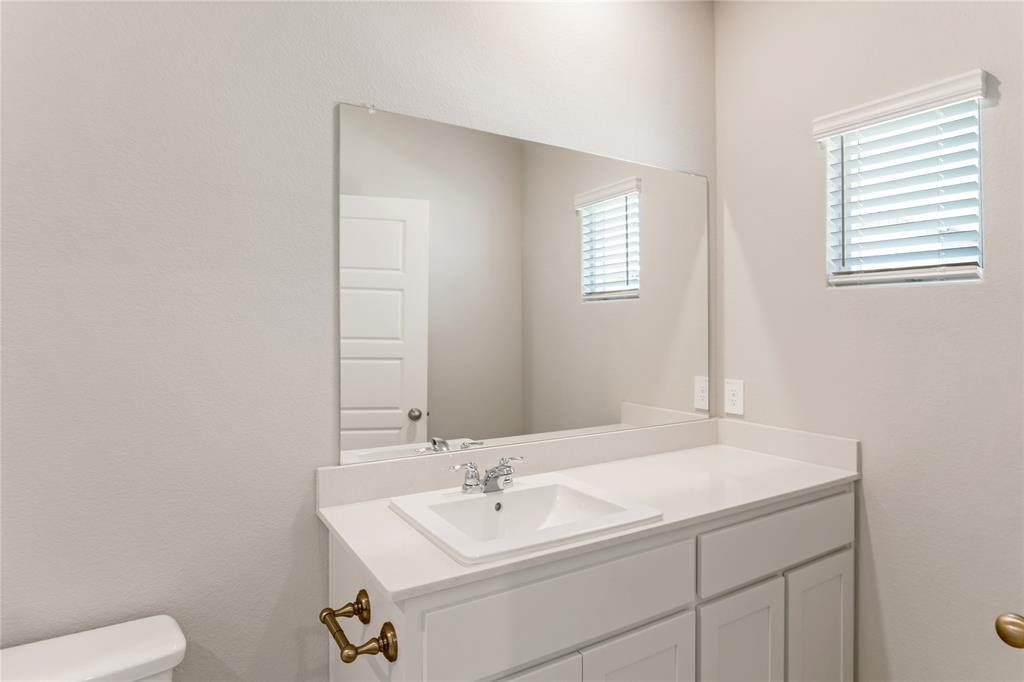 3116 Pecan Farm Lane Fort Worth, TX 76140 - Photo 6 of 25 a bathroom with a sink a toilet and a mirror