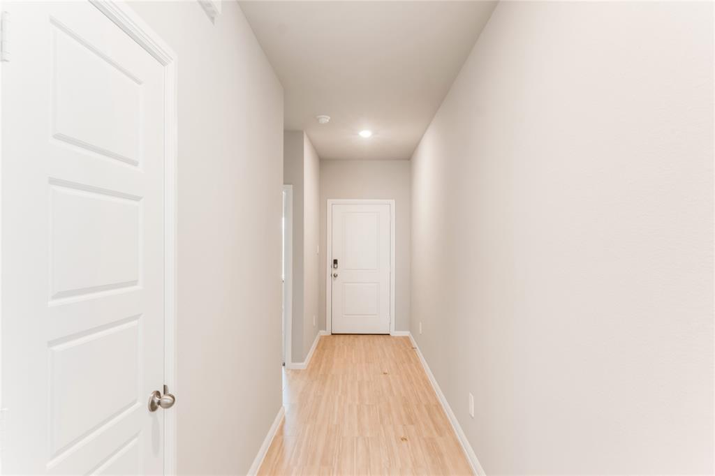 3116 Pecan Farm Lane Fort Worth, TX 76140 - Photo 10 of 25 a view of a hallway with wooden floor