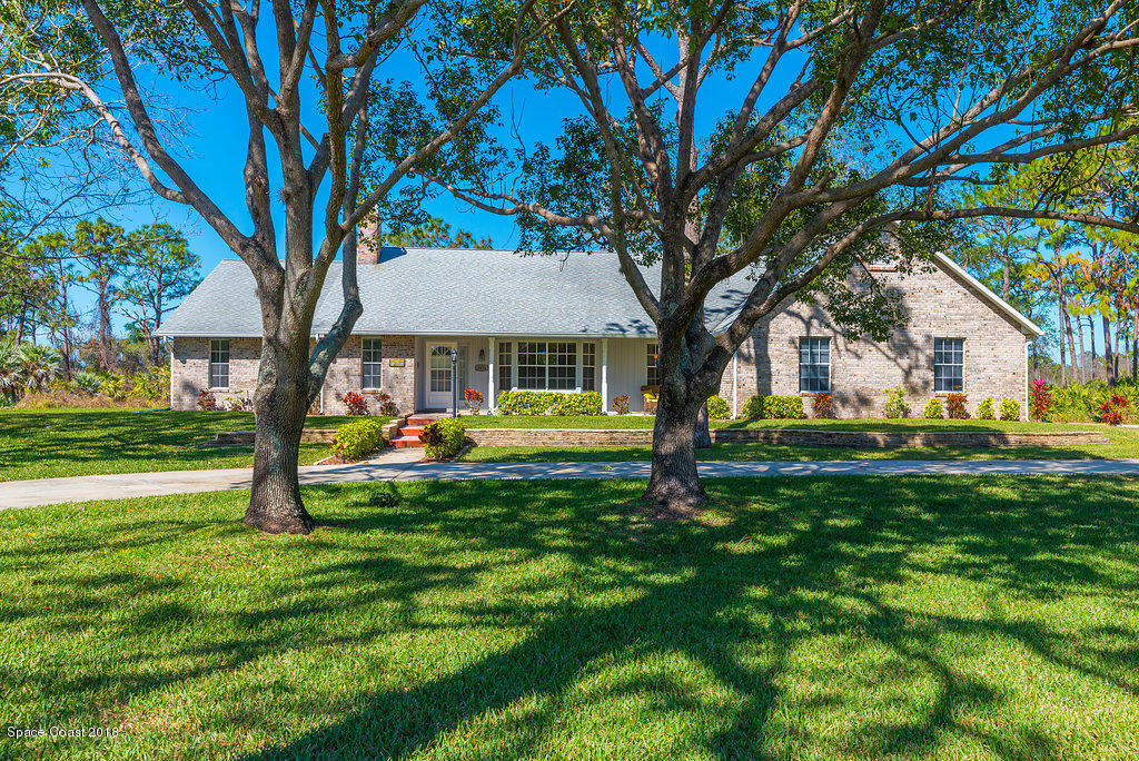 3956 Sparrow Hawk Road Melbourne, FL 32934 - Photo 1 of 34 a view of a house with a yard