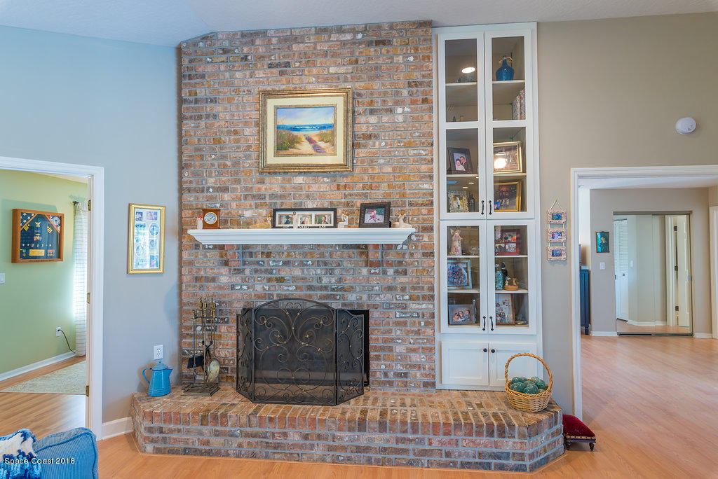 3956 Sparrow Hawk Road Melbourne, FL 32934 - Photo 14 of 34 a living room with furniture and a fireplace