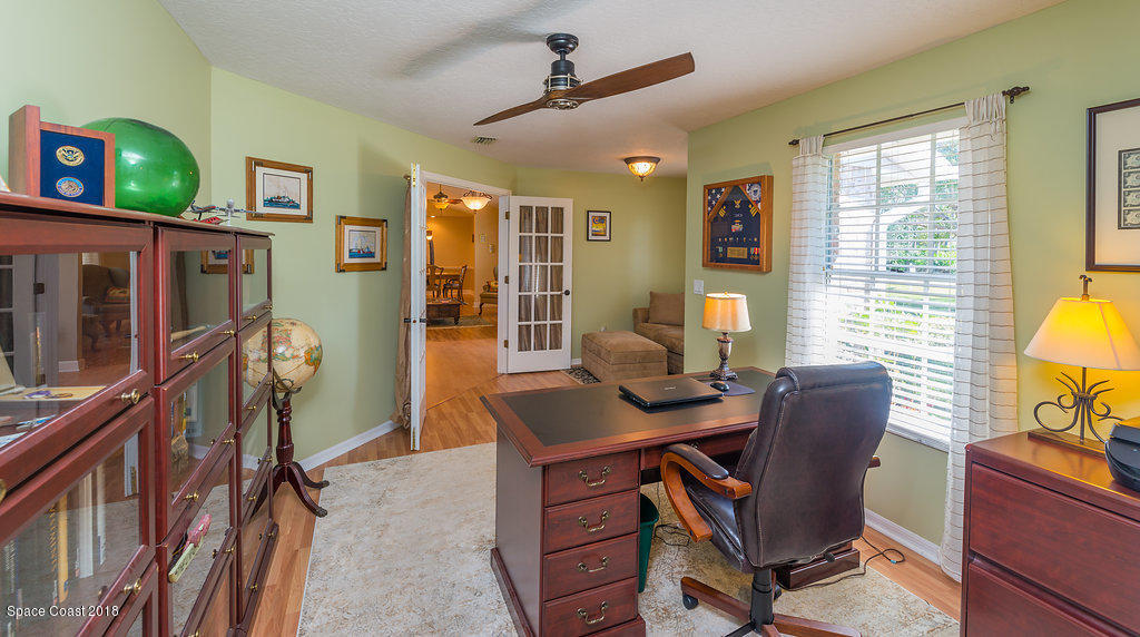 3956 Sparrow Hawk Road Melbourne, FL 32934 - Photo 20 of 34 a view of a workspace with furniture and a window