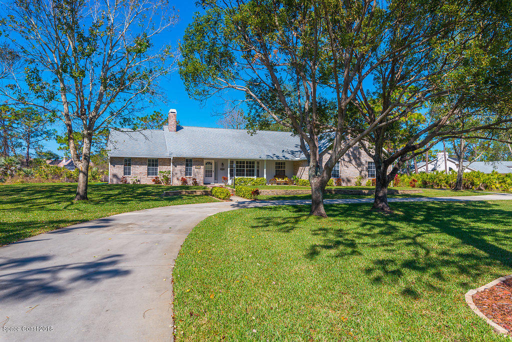 3956 Sparrow Hawk Road Melbourne, FL 32934 - Photo 3 of 34 a front view of a house with yard and green space