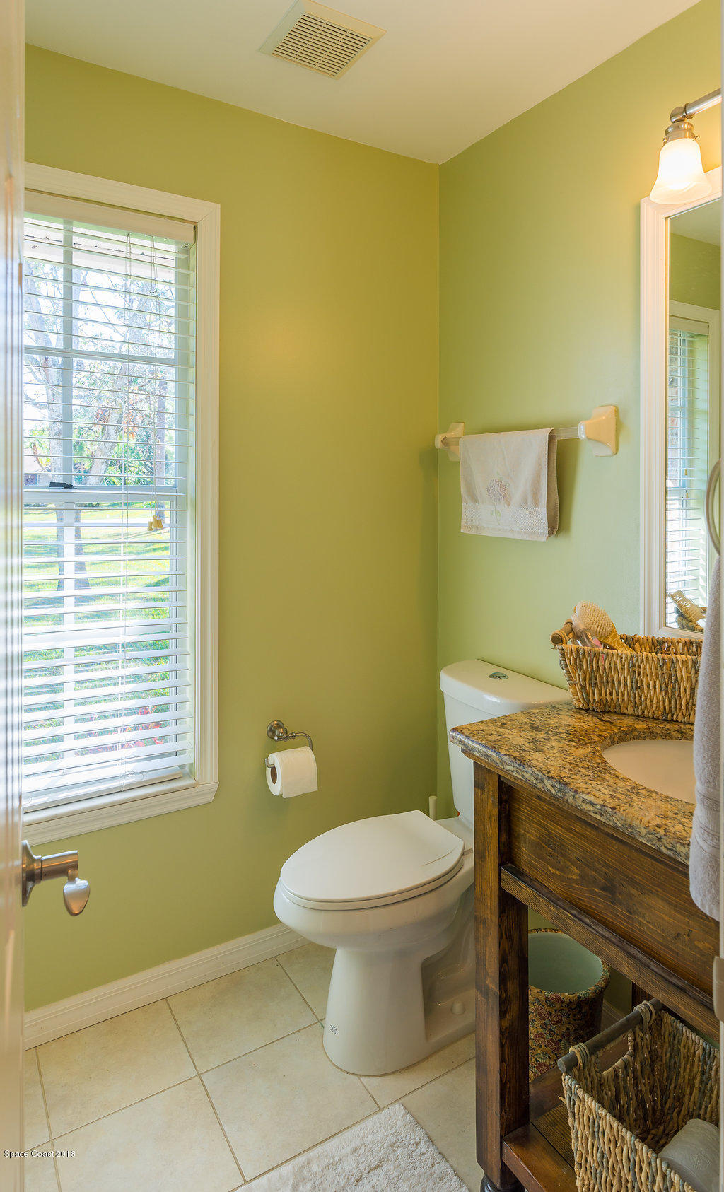 3956 Sparrow Hawk Road Melbourne, FL 32934 - Photo 21 of 34 a bathroom with a toilet a sink and a mirror