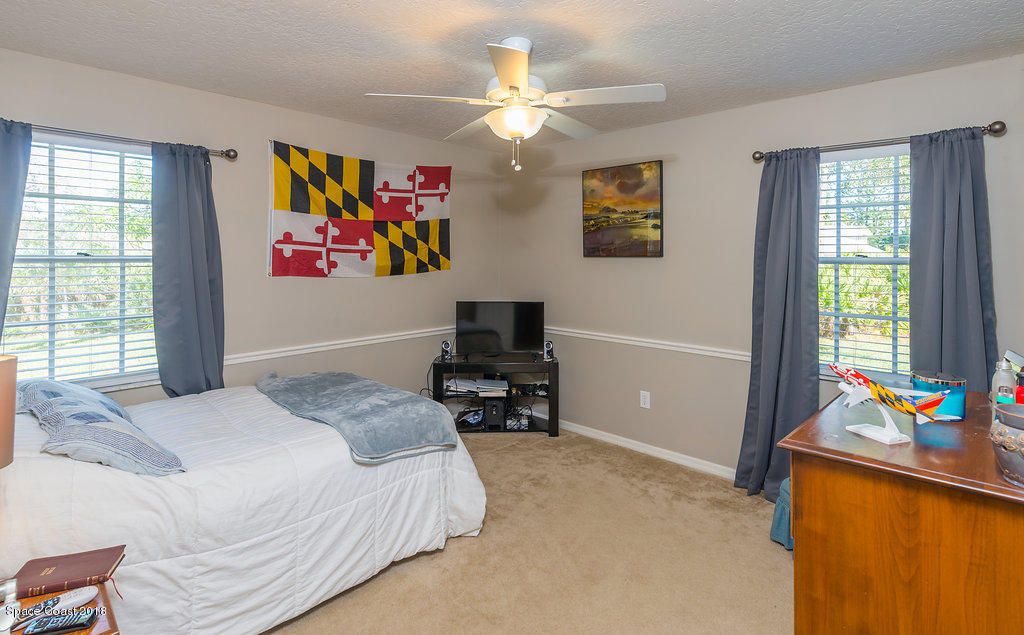 3956 Sparrow Hawk Road Melbourne, FL 32934 - Photo 23 of 34 a bedroom with a bed furniture and a window