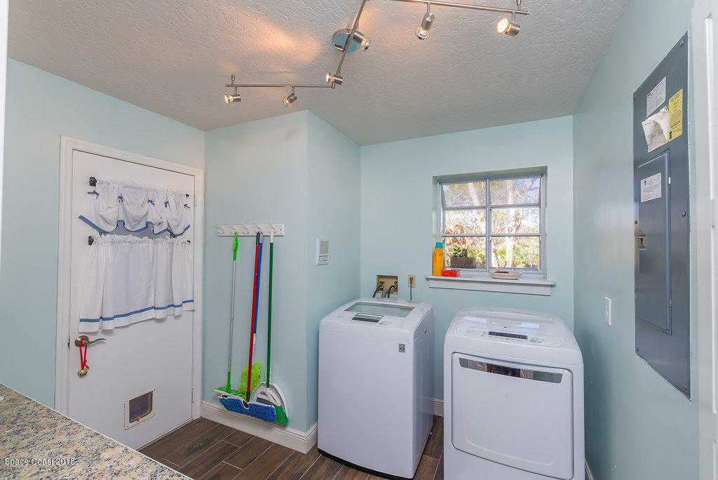 3956 Sparrow Hawk Road Melbourne, FL 32934 - Photo 26 of 34 a utility room with dryer and washer