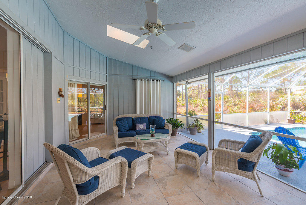 3956 Sparrow Hawk Road Melbourne, FL 32934 - Photo 27 of 34 a living room with furniture and floor to ceiling windows
