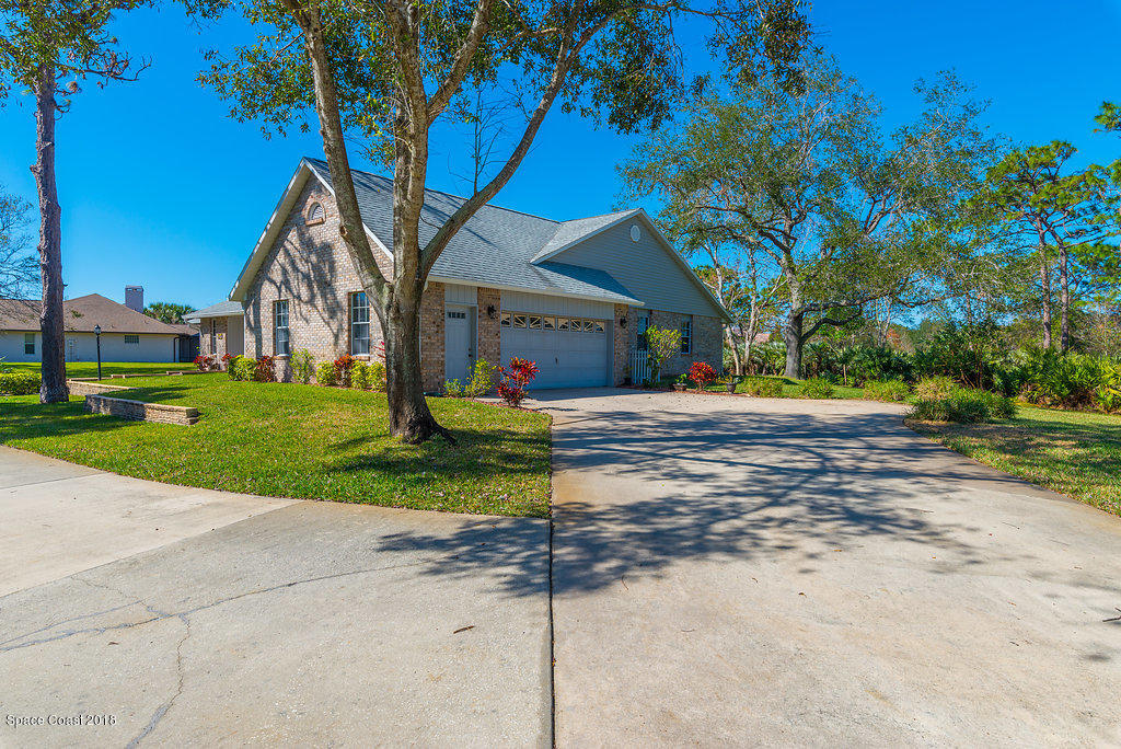 3956 Sparrow Hawk Road Melbourne, FL 32934 - Photo 4 of 34 a front view of a house with a yard