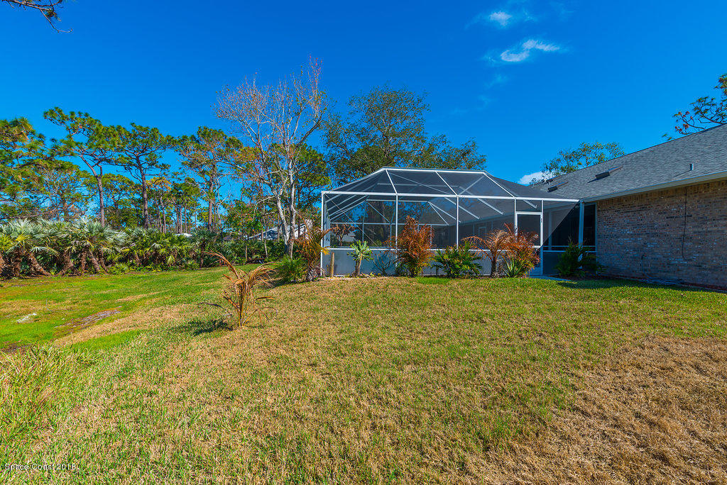 3956 Sparrow Hawk Road Melbourne, FL 32934 - Photo 31 of 34 a view of a yard with a house in the background