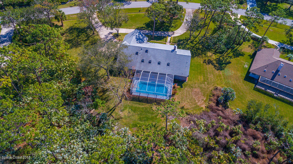 3956 Sparrow Hawk Road Melbourne, FL 32934 - Photo 33 of 34 an aerial view of a house with a yard swimming pool and outdoor seating